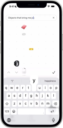 Anchor natural-language search reading ‘Objects that bring me joy’ with the keyboard open.